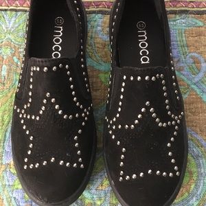 Canvas slip-ons with silver grommets forming a star